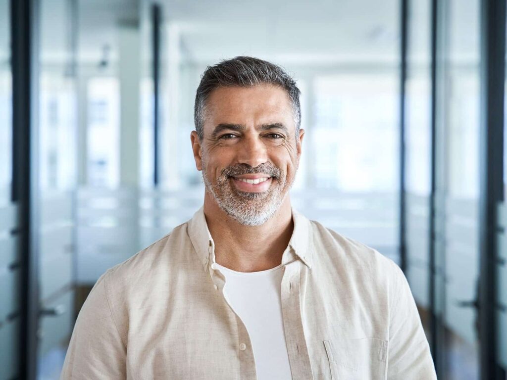 Man showing off smile after receiving sleep apnea treatment