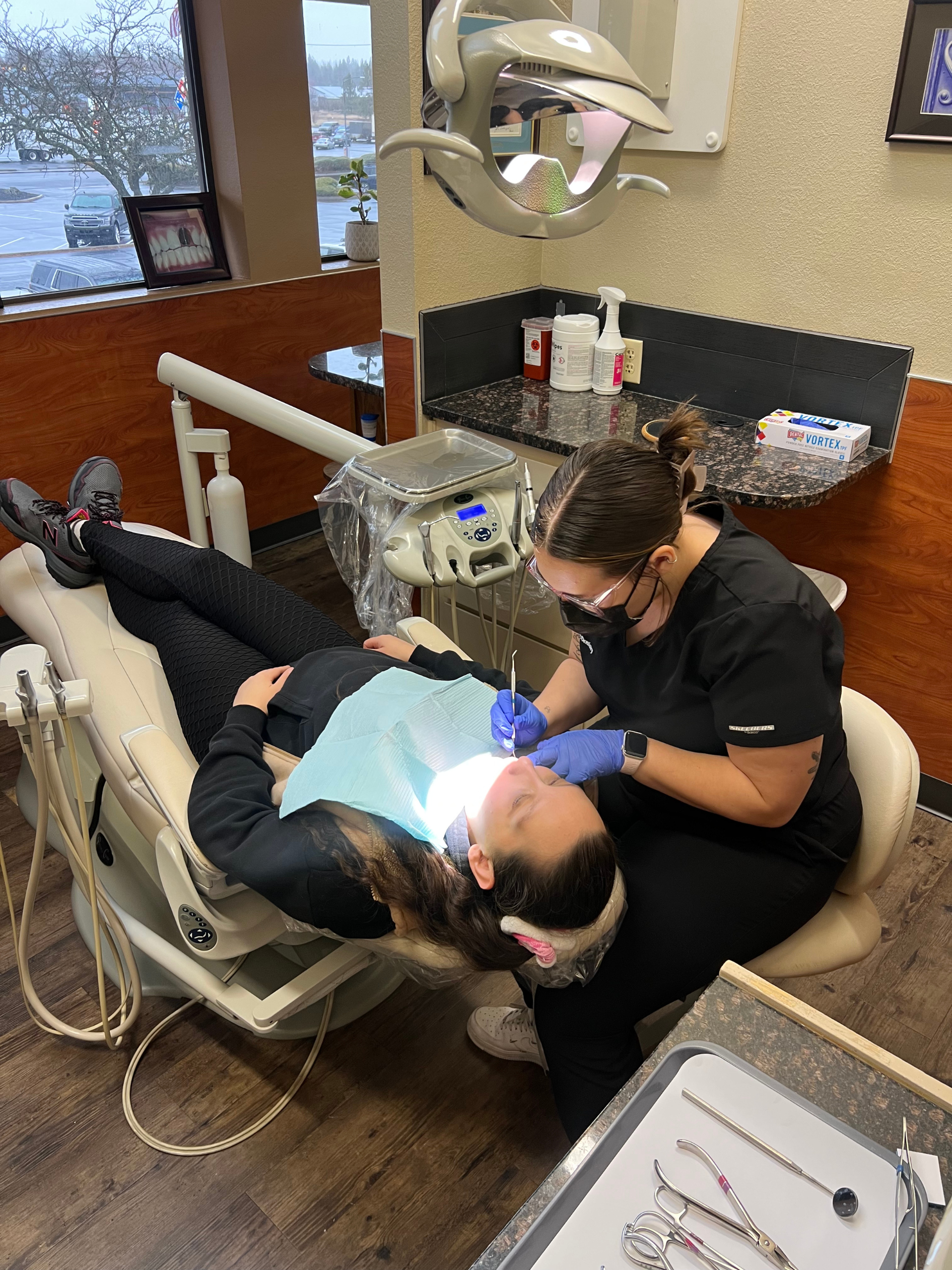 Dental hygienist providing care at Collins Family Dentistry
